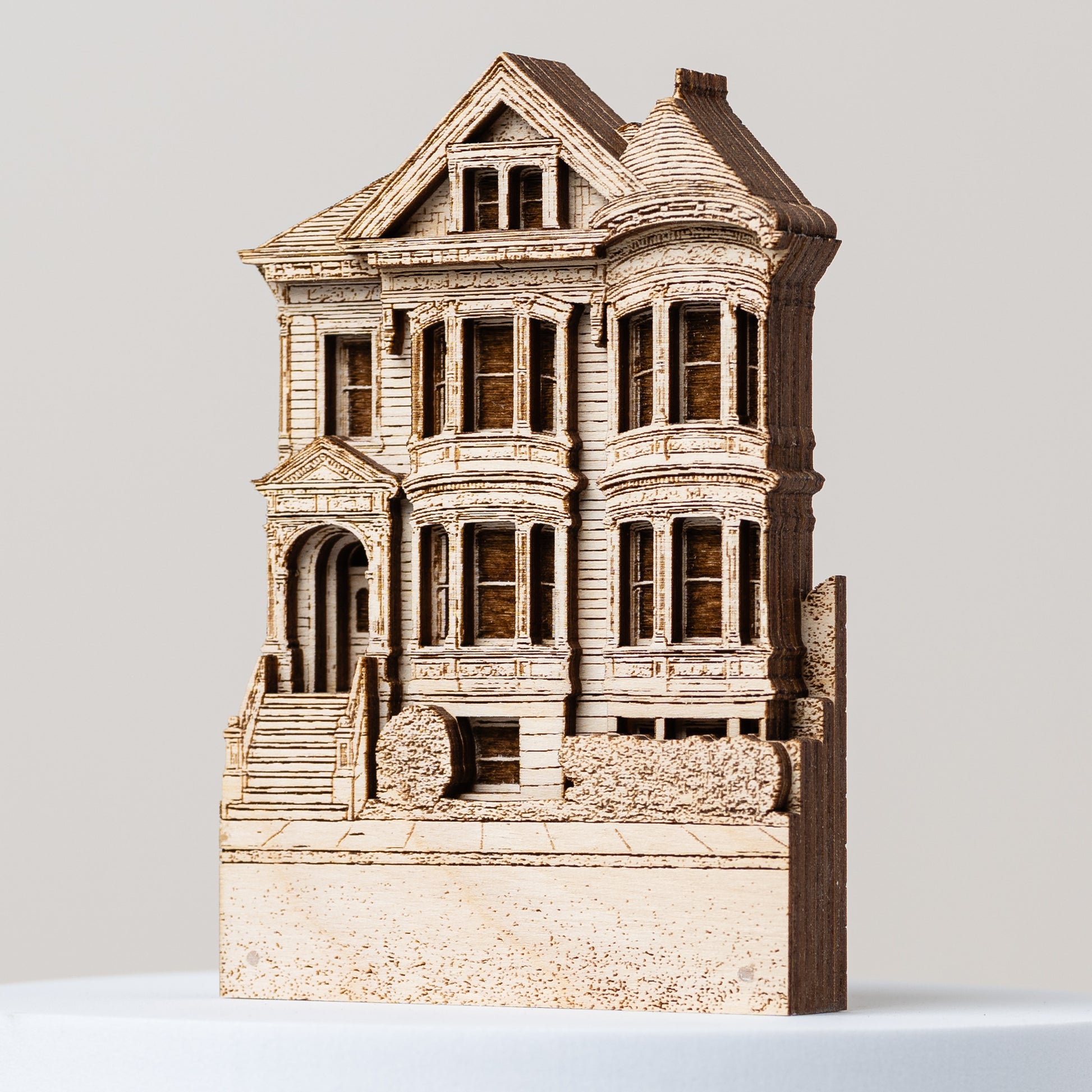 Model of a Victorian-style house on a light gray background