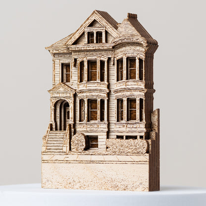 Model of a Victorian-style house on a light gray background