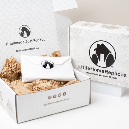 White box with wooden models and 'LittleHomeReplicas' branding on a white background