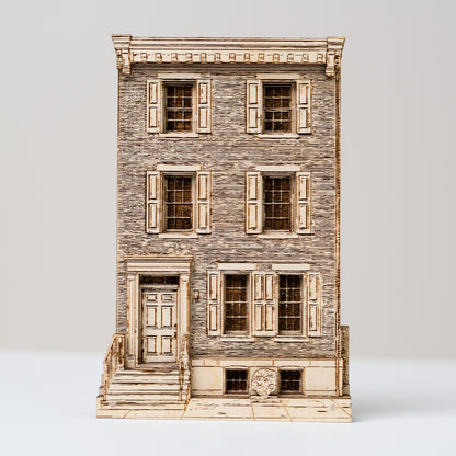 Model of a multi-story building with wooden facade and shutters on a white background