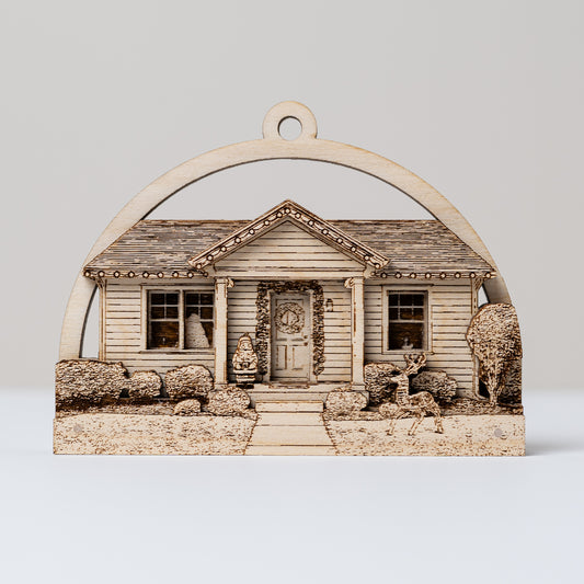 Decorative wooden ornament of a house with a door and windows on a plain background