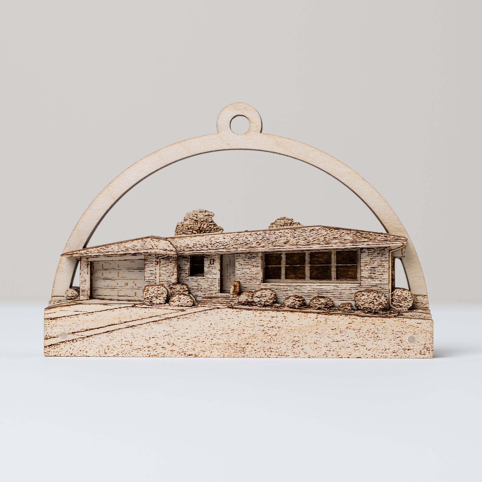 Wooden ornament of a house with an arch on a white background